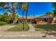 Charming brick home features a tile roof, green lawn, mature trees, and inviting walkway at 28 E 14Th St, Tempe, AZ 85281