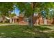 Charming brick home is surrounded by mature trees and a lush green lawn at 28 E 14Th St, Tempe, AZ 85281