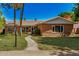 Charming brick home features a tile roof, green lawn, mature trees, and inviting walkway at 28 E 14Th St, Tempe, AZ 85281
