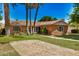 Inviting brick home boasts a terracotta tile roof, lush lawn, and mature shade trees at 28 E 14Th St, Tempe, AZ 85281