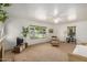Bright living room with ceiling fan, large windows and classic neutral carpet and paint at 28 E 14Th St, Tempe, AZ 85281