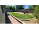 Landscaped back yard features a well maintained lawn and concrete block perimeter wall at 3526 E Piccadilly Rd, Phoenix, AZ 85018