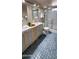 Well-lit bathroom featuring double sinks, updated fixtures, and a glass enclosed shower at 3526 E Piccadilly Rd, Phoenix, AZ 85018