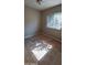 This is a bright bedroom with neutral walls, a window, and tile flooring at 3526 E Piccadilly Rd, Phoenix, AZ 85018
