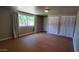 Bright bedroom features wood-look floors, a window, and double door closets at 3526 E Piccadilly Rd, Phoenix, AZ 85018