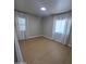 Cozy bedroom with ample natural light, two windows, and gleaming laminate floors at 3526 E Piccadilly Rd, Phoenix, AZ 85018