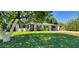 Inviting home featuring a lush green lawn and a modern front door at 3526 E Piccadilly Rd, Phoenix, AZ 85018