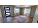 Bright living room featuring hardwood floors, light neutral walls, and large windows at 3526 E Piccadilly Rd, Phoenix, AZ 85018