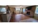 Open living room with a brick fireplace and mantel, and bar with counter seating at 3526 E Piccadilly Rd, Phoenix, AZ 85018