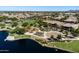 This aerial view highlights the community lake, playground, and basketball court surrounded by homes and lush landscaping at 3664 E Narrowleaf Dr, Gilbert, AZ 85298