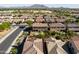 Wide aerial shot of a desert home with pool, lawn, and patio, nestled in a thriving residential community at 3664 E Narrowleaf Dr, Gilbert, AZ 85298
