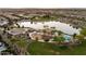 Aerial view of lake and park amenities, including playground and basketball court, in residential area at 3664 E Narrowleaf Dr, Gilbert, AZ 85298