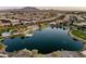 Aerial view of a lake in a residential community featuring mature landscaping and mountain views at 3664 E Narrowleaf Dr, Gilbert, AZ 85298