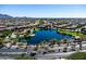 Picturesque aerial view of a Primary-planned community featuring a large lake and mountain views in the distance at 3664 E Narrowleaf Dr, Gilbert, AZ 85298