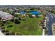Scenic aerial shot of a planned community boasting a lake, park, green spaces and well-manicured lawns at 3664 E Narrowleaf Dr, Gilbert, AZ 85298