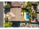 Overhead aerial shot displaying a backyard oasis with a swimming pool, patio, desert plants and green grass at 3664 E Narrowleaf Dr, Gilbert, AZ 85298