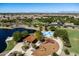 Aerial view of a park with a lake, splash pad, playground, picnic area and wide open green spaces at 3664 E Narrowleaf Dr, Gilbert, AZ 85298