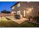 A backyard barbecue area features seating, built in grill, artificial grass and tile pavers at 3664 E Narrowleaf Dr, Gilbert, AZ 85298