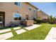 An outdoor kitchen featuring a built in grill and adjacent artificial turf creates a relaxing space at 3664 E Narrowleaf Dr, Gilbert, AZ 85298