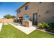 Artificial turf and stone accents compliment the outdoor kitchen, grill, and bar seating at 3664 E Narrowleaf Dr, Gilbert, AZ 85298