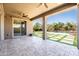 Inviting covered patio with a view of the lush backyard, pool, and outdoor living space at 3664 E Narrowleaf Dr, Gilbert, AZ 85298