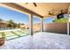 Spacious backyard with a covered patio, lush landscaping, a pool, and ample space for outdoor living at 3664 E Narrowleaf Dr, Gilbert, AZ 85298