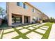 Home backyard featuring covered patio, outdoor kitchen, basketball hoop, lush lawn, and stylish stone accents at 3664 E Narrowleaf Dr, Gilbert, AZ 85298