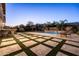 The backyard features a basketball hoop, stone pavers, grass and a seating area at 3664 E Narrowleaf Dr, Gilbert, AZ 85298