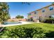 Landscaped backyard with lush lawn, pool with waterfall, and outdoor kitchen at 3664 E Narrowleaf Dr, Gilbert, AZ 85298