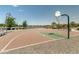 Community basketball court with well-maintained surface and lakeside views at 3664 E Narrowleaf Dr, Gilbert, AZ 85298