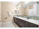 Bathroom with dual sinks, dark wood cabinetry, decorative tile backsplash, and large mirror for a spa-like experience at 3664 E Narrowleaf Dr, Gilbert, AZ 85298
