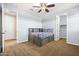 Comfortable bedroom with ceiling fan, a cozy bed with built in shelves and easy access to a walk in closet at 3664 E Narrowleaf Dr, Gilbert, AZ 85298