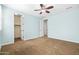 Open bedroom features a ceiling fan, blue walls and easy access to walk in closet and other areas of the home at 3664 E Narrowleaf Dr, Gilbert, AZ 85298