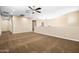 An open and spacious bonus room with ceiling fan, neutral paint and generous lighting offers versatile living space at 3664 E Narrowleaf Dr, Gilbert, AZ 85298