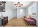 Versatile bonus room with a purple chaise lounge, a wet bar, and a ceiling fan at 3664 E Narrowleaf Dr, Gilbert, AZ 85298