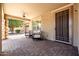 Relaxing covered patio featuring brick pavers, comfortable seating, and views of the lush backyard at 3664 E Narrowleaf Dr, Gilbert, AZ 85298