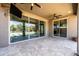 Covered patio with travertine tile flooring, ceiling fans, and views of the serene backyard and pool at 3664 E Narrowleaf Dr, Gilbert, AZ 85298