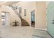 Spacious foyer with staircase and tiled flooring with views into an additional room at 3664 E Narrowleaf Dr, Gilbert, AZ 85298