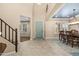Inviting foyer featuring a tiled floor, staircase, and dining area with windows offering natural light at 3664 E Narrowleaf Dr, Gilbert, AZ 85298