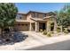 Attractive two-story home with stone accents, desert landscaping, and a spacious driveway leading to the garage at 3664 E Narrowleaf Dr, Gilbert, AZ 85298
