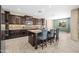 A spacious kitchen features dark wood cabinets, a large island with seating, and modern stainless steel appliances at 3664 E Narrowleaf Dr, Gilbert, AZ 85298