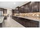 The kitchen features granite countertops, mosaic tile backsplash, stainless steel appliances, and dark wood cabinetry at 3664 E Narrowleaf Dr, Gilbert, AZ 85298