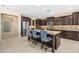The well-appointed kitchen boasts stainless appliances, dark wood cabinetry, a central island, and ample countertop space at 3664 E Narrowleaf Dr, Gilbert, AZ 85298
