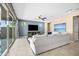 Inviting living room features a comfortable white sofa, ceiling fan, and sliding doors to the backyard at 3664 E Narrowleaf Dr, Gilbert, AZ 85298