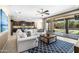 Open-concept living room features a comfortable sectional, backyard access, and seamless flow to the kitchen at 3664 E Narrowleaf Dr, Gilbert, AZ 85298