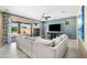 Spacious living room features backyard access, a comfortable white sectional, and modern decor at 3664 E Narrowleaf Dr, Gilbert, AZ 85298