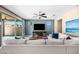 Cozy living room features a comfortable white sectional, ceiling fan, and ample natural light at 3664 E Narrowleaf Dr, Gilbert, AZ 85298