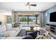 Bright living room with backyard views features a comfortable sectional sofa and stylish decor at 3664 E Narrowleaf Dr, Gilbert, AZ 85298