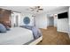 Spacious main bedroom with gray walls, a ceiling fan, access to en-suite, and a wall-mounted television at 3664 E Narrowleaf Dr, Gilbert, AZ 85298