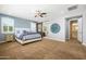 Large main bedroom featuring a ceiling fan, big windows, and an en-suite with a barn door at 3664 E Narrowleaf Dr, Gilbert, AZ 85298